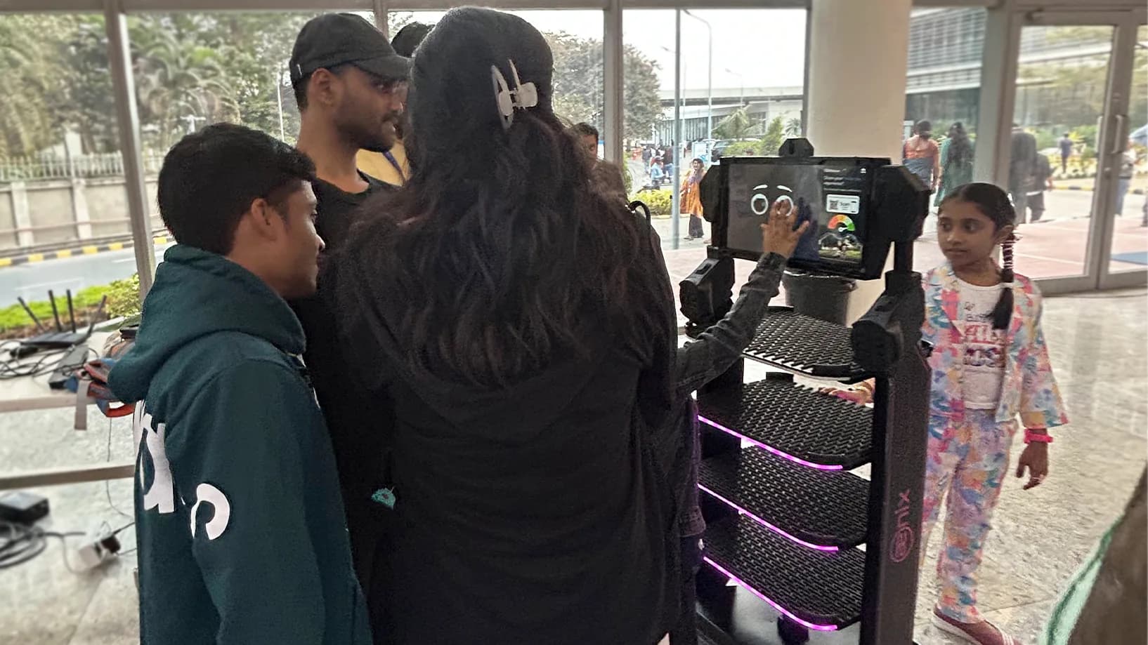 Misti service robot drawing a crowd outdoors